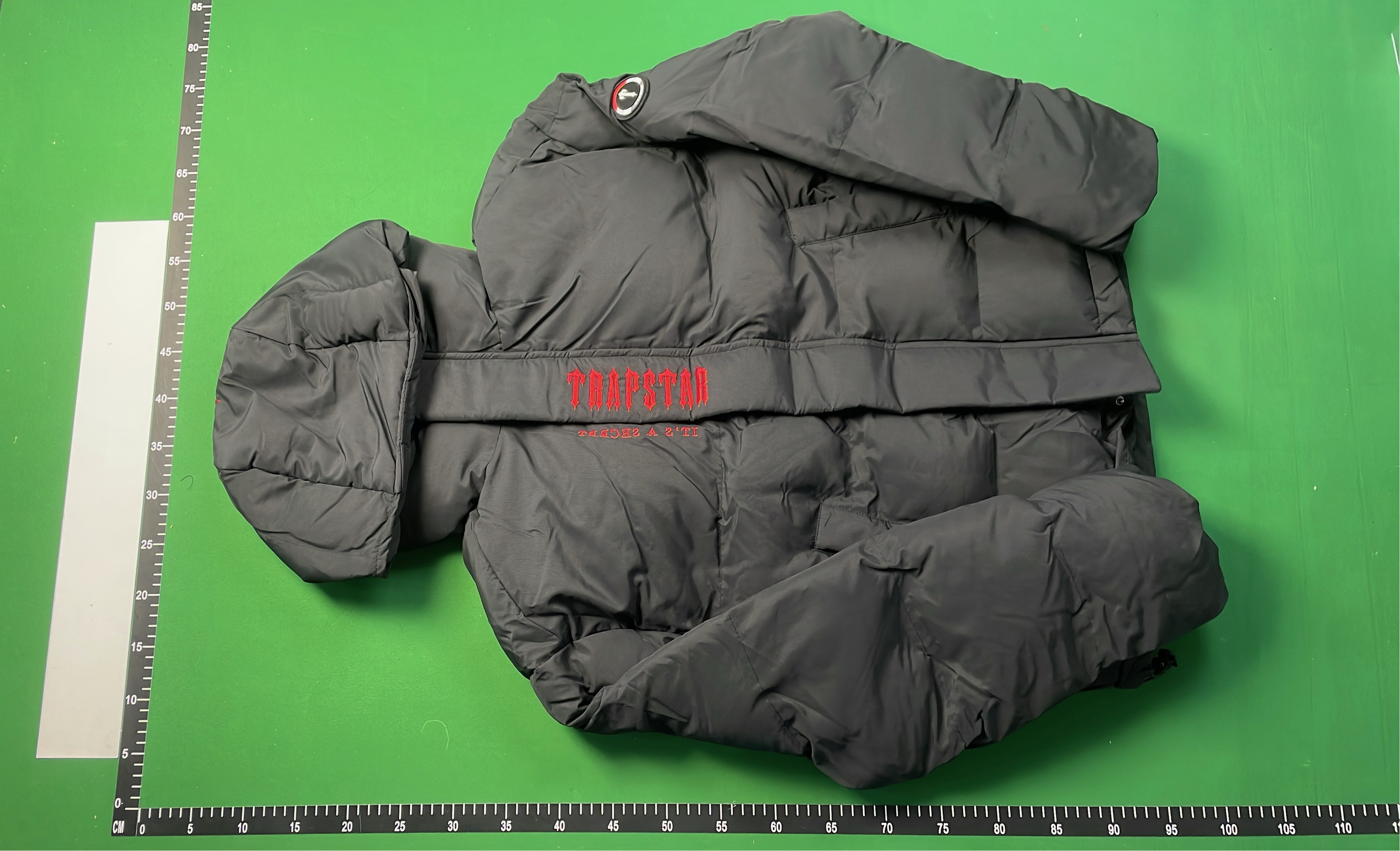 Black Hooded Puffer Jacket with Red Accent Design
