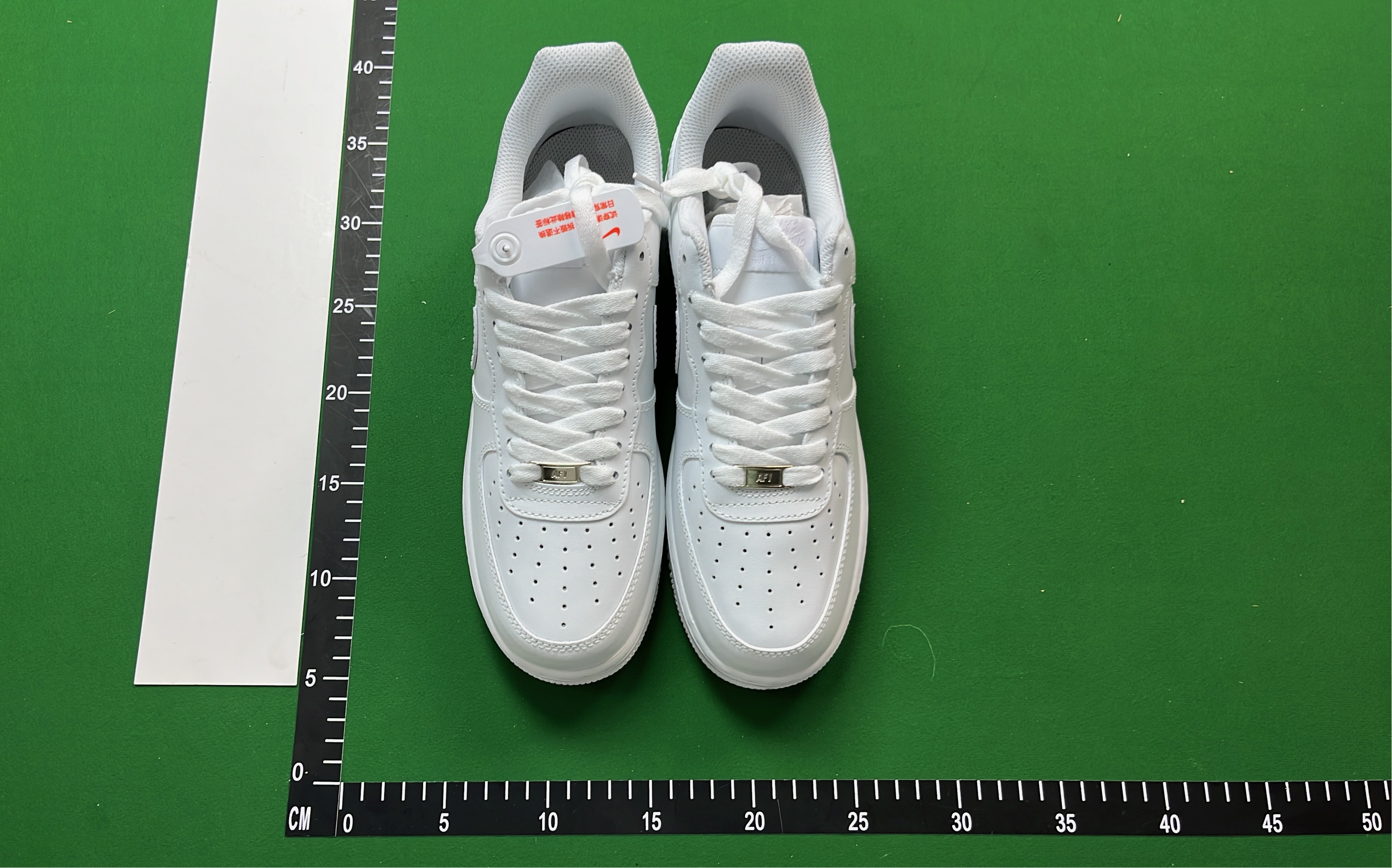 White Low-Top Sneakers with Pixelated Swoosh Design