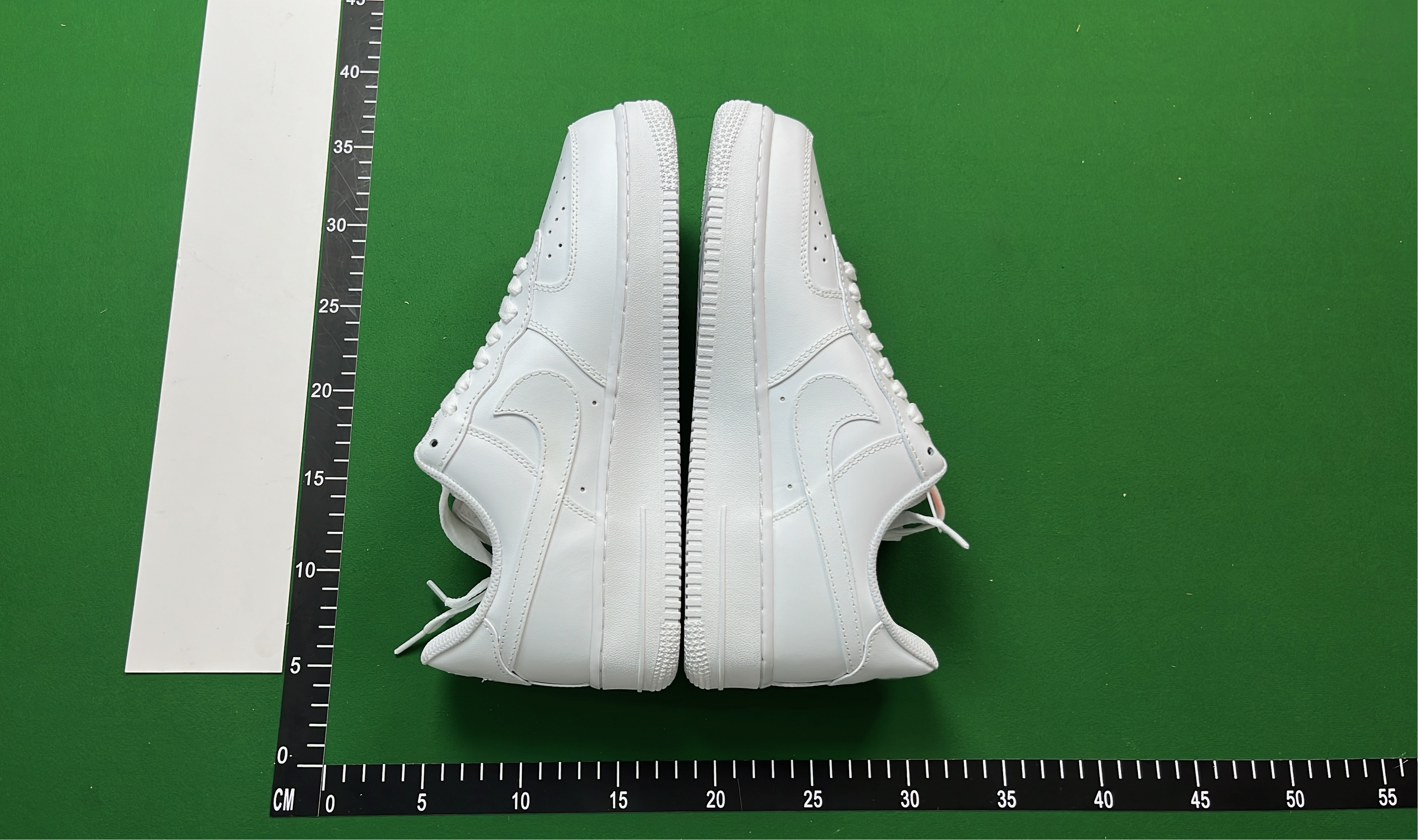 White Low-Top Sneakers with Pixelated Swoosh Design