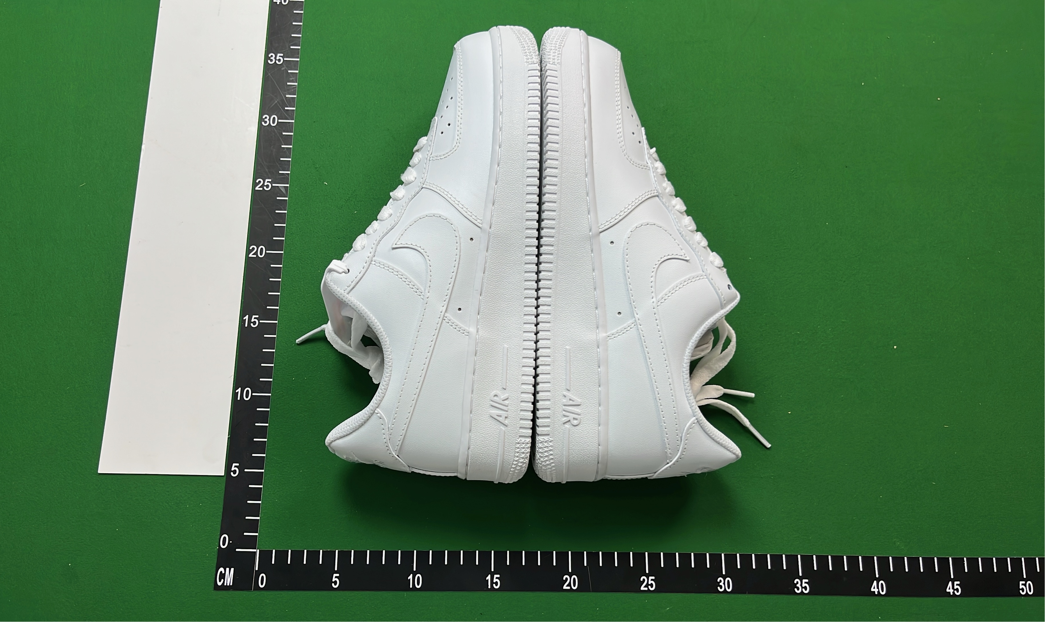 White Low-Top Sneakers with Pixelated Swoosh Design