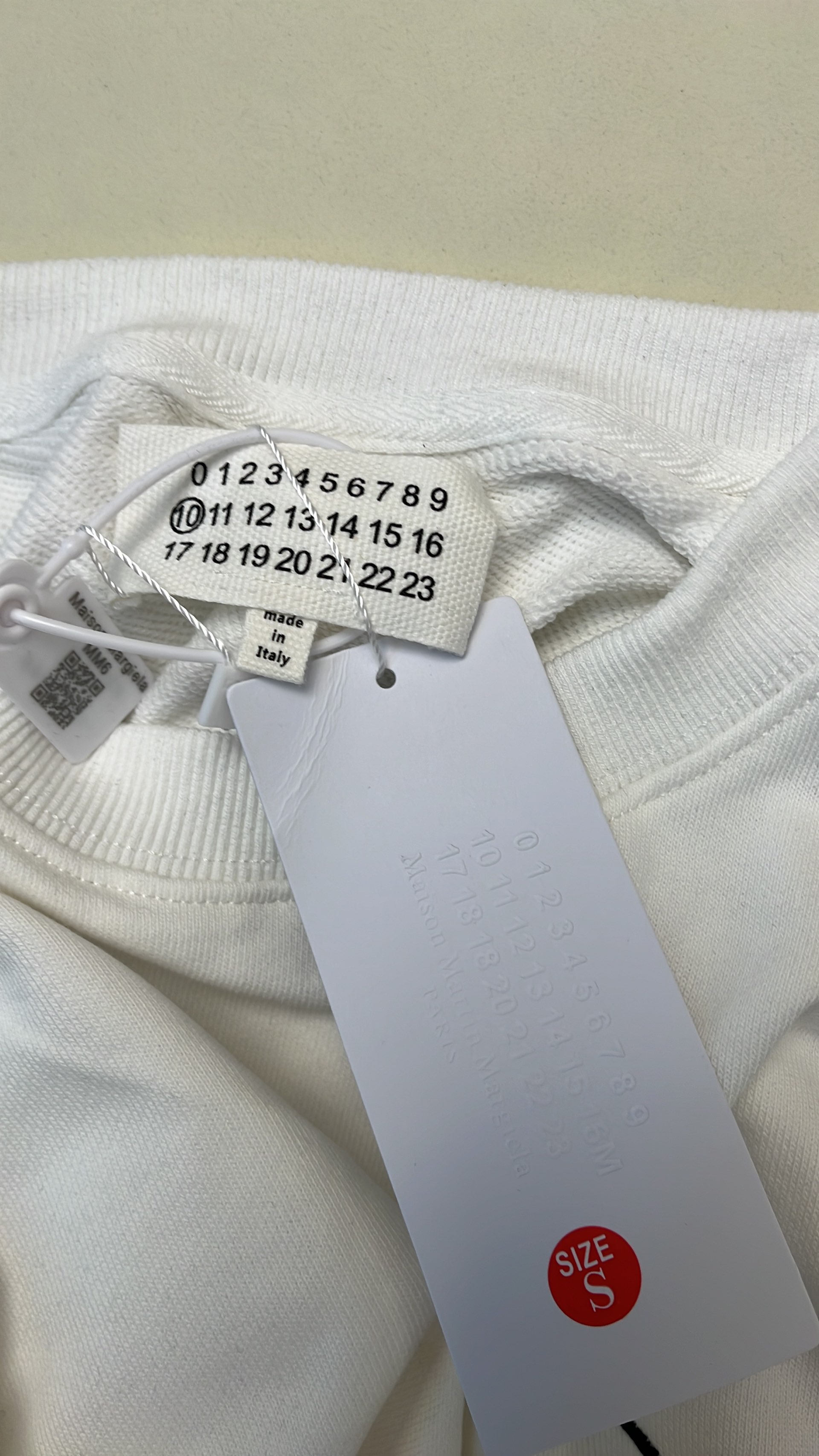 Black Minimalist Sweatshirt with Subtle Cross Logo