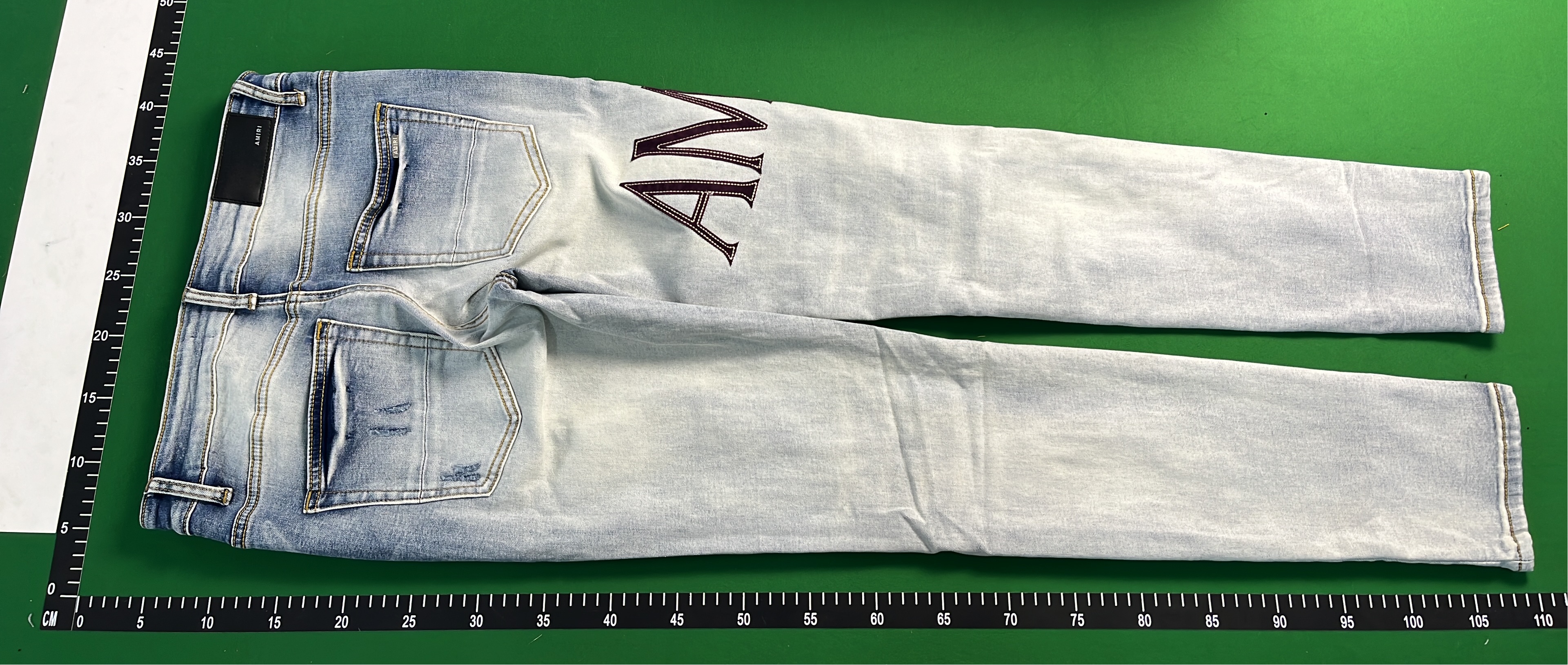 Ripped Denim Jeans with Bold Lettering for Men