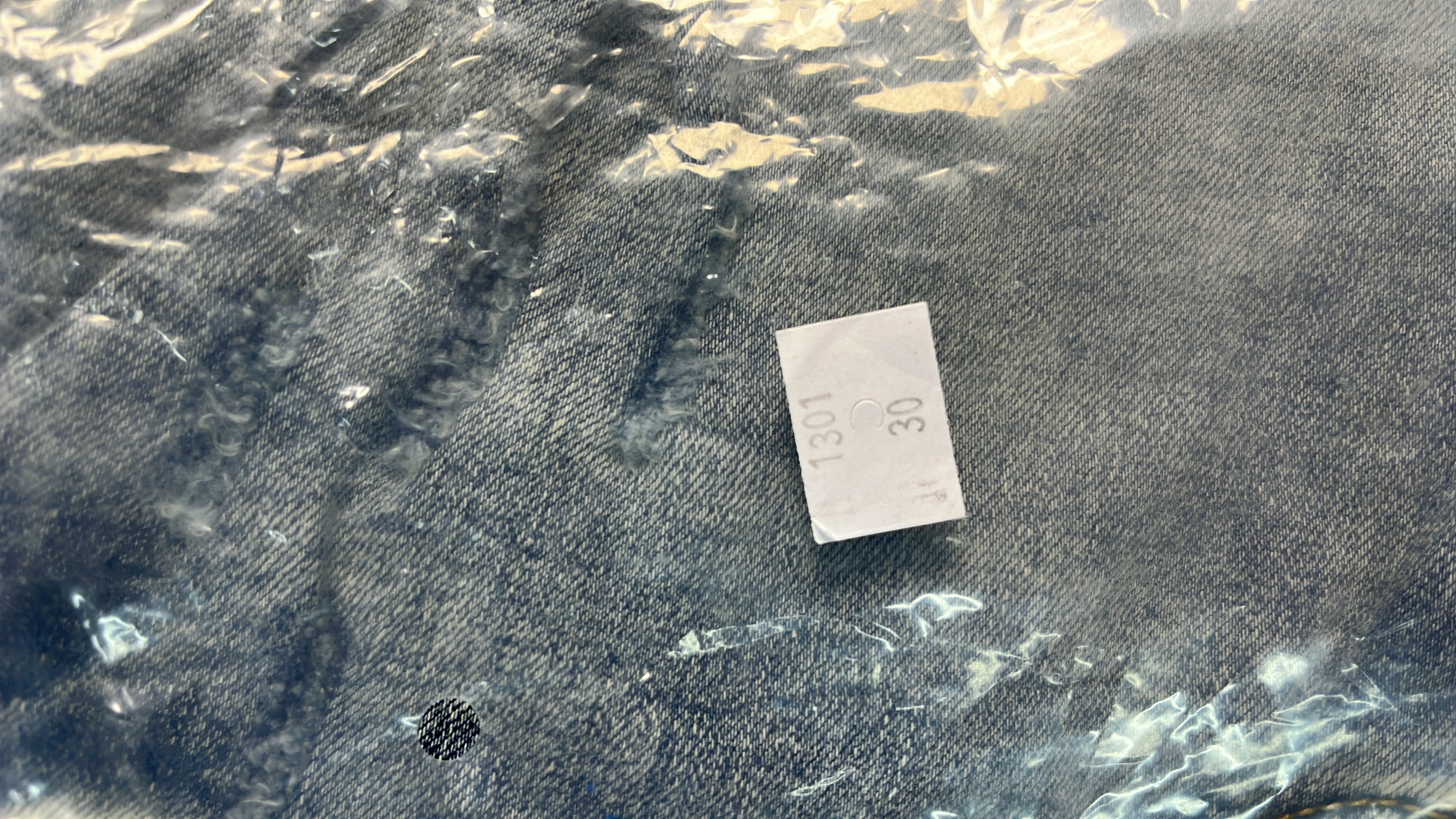 Ripped Denim Jeans with Bold Lettering for Men