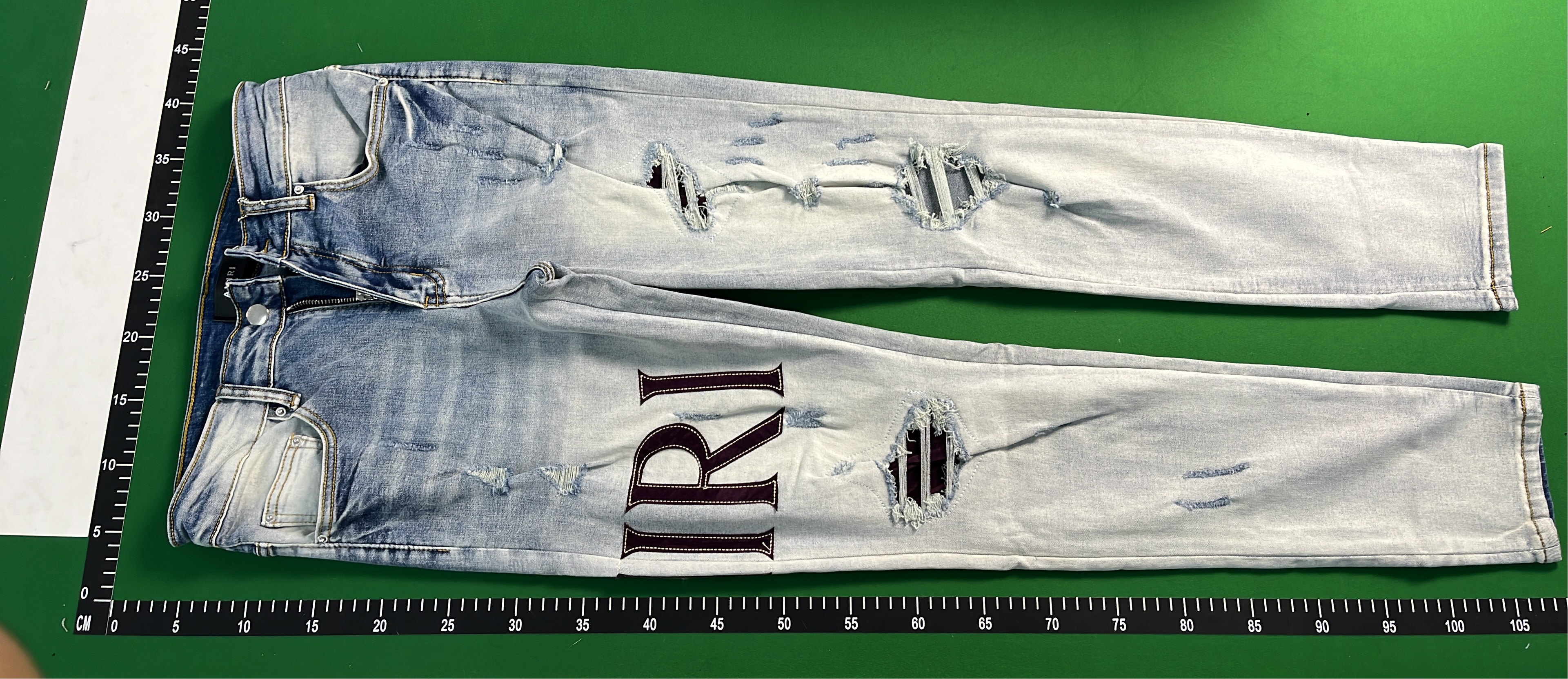 Ripped Denim Jeans with Bold Lettering for Men