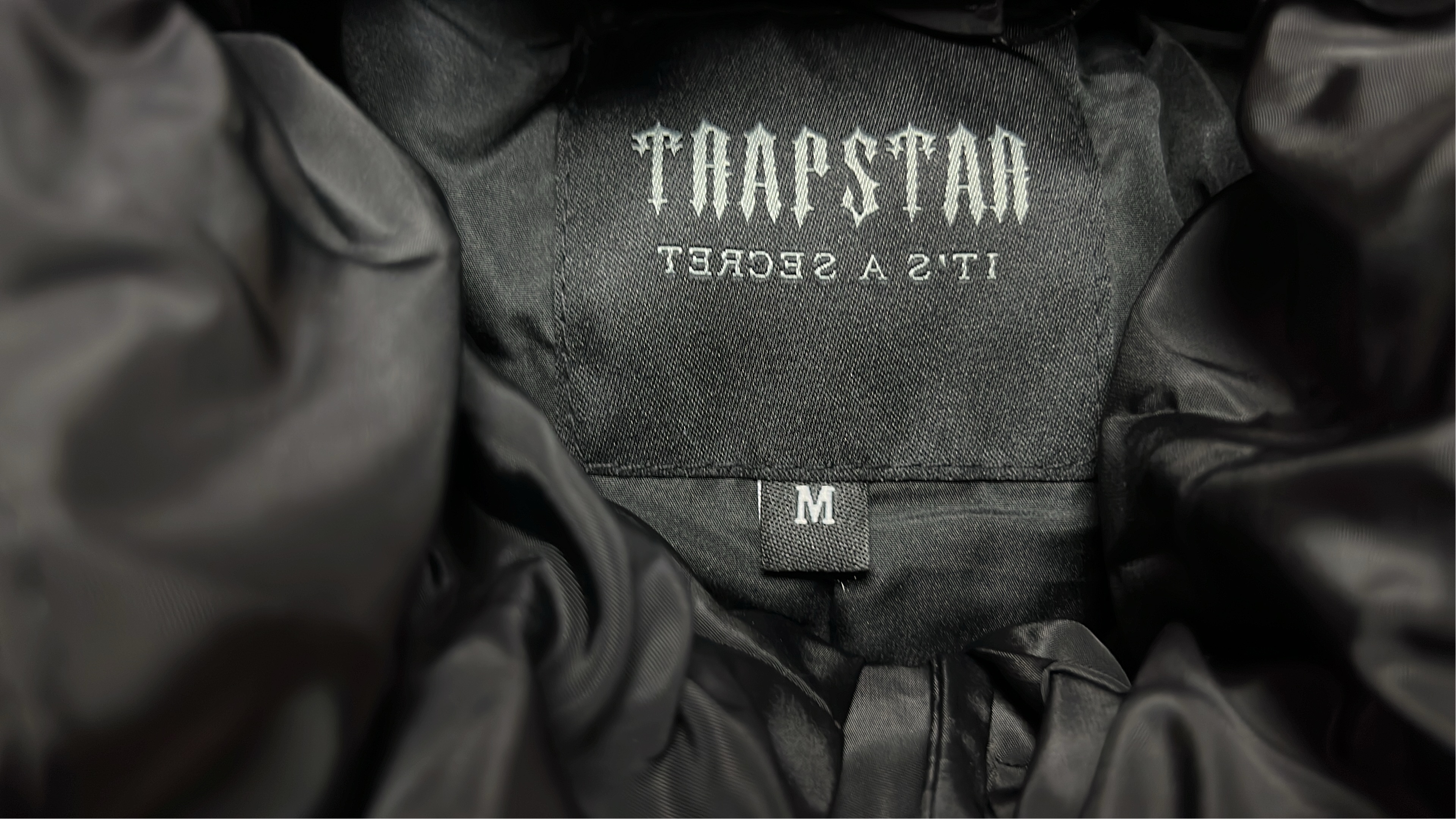 TRAPSTAR Black Puffer Jacket with Gothic Lettering