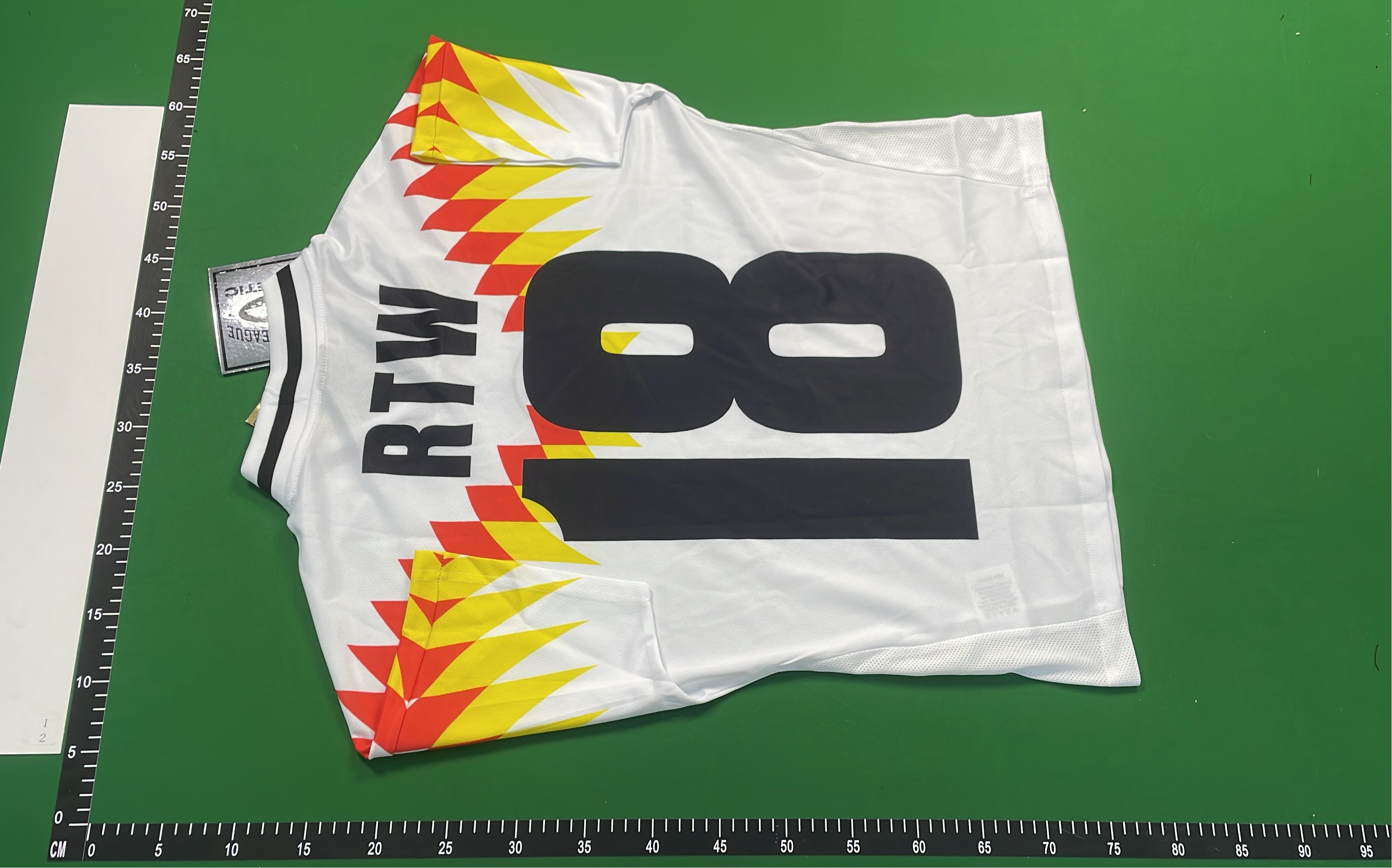 White Geometric Pattern T-Shirt with Red and Yellow Design