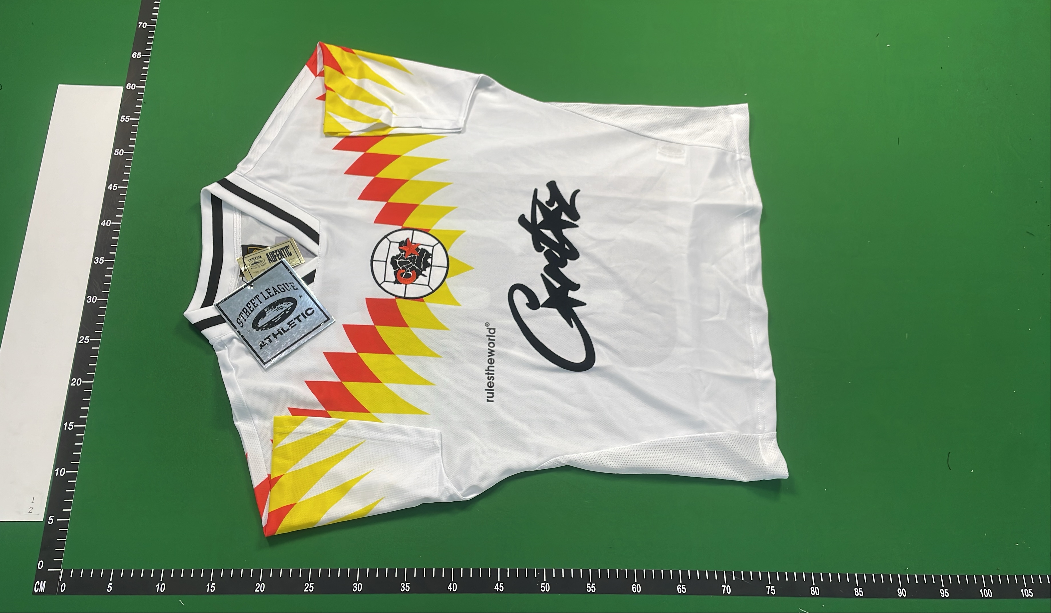 White Geometric Pattern T-Shirt with Red and Yellow Design