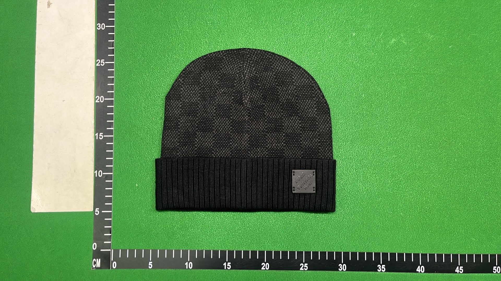 Black Knit Beanie with Patterned Design and Metal Tag
