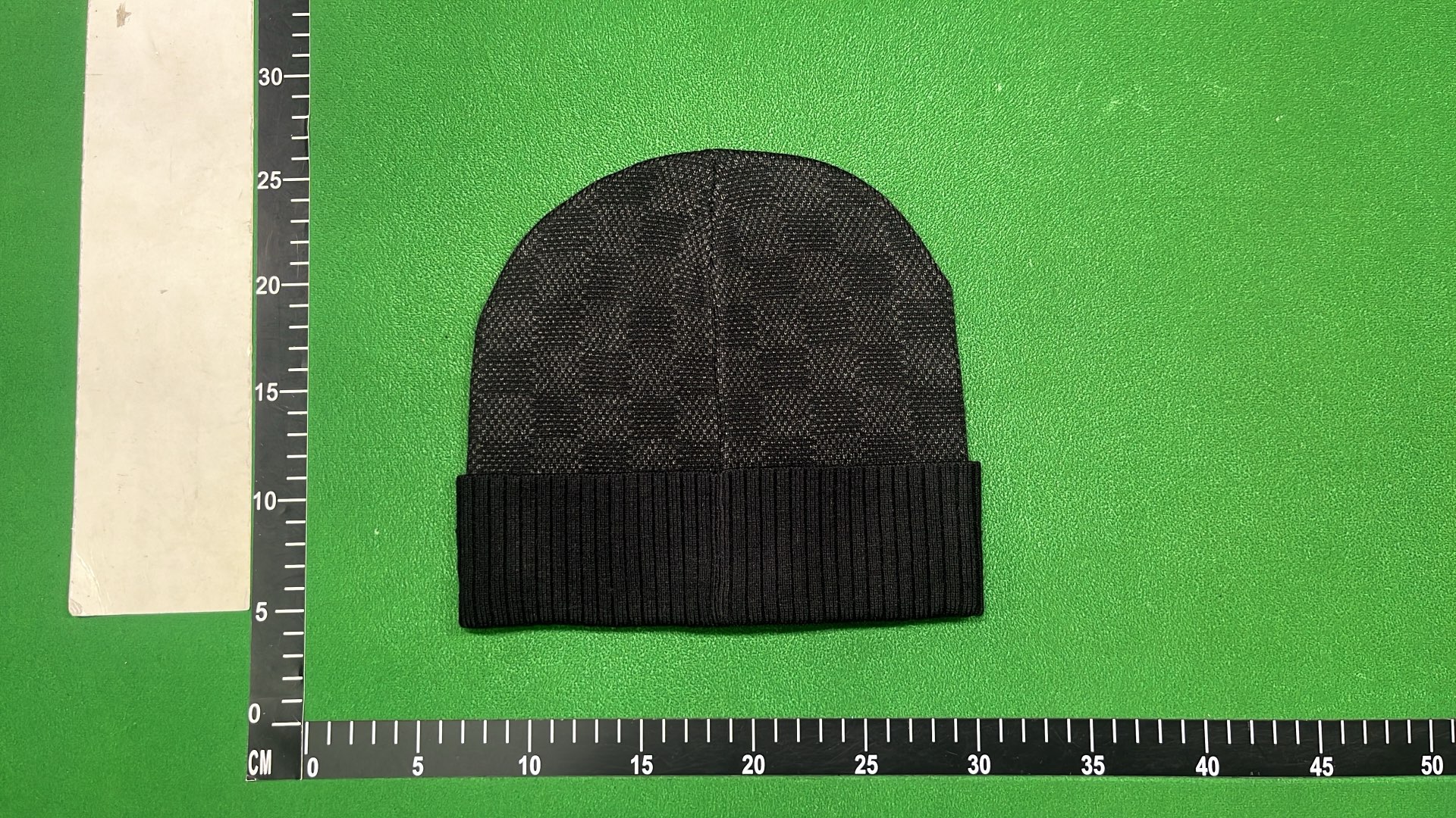 Black Knit Beanie with Patterned Design and Metal Tag