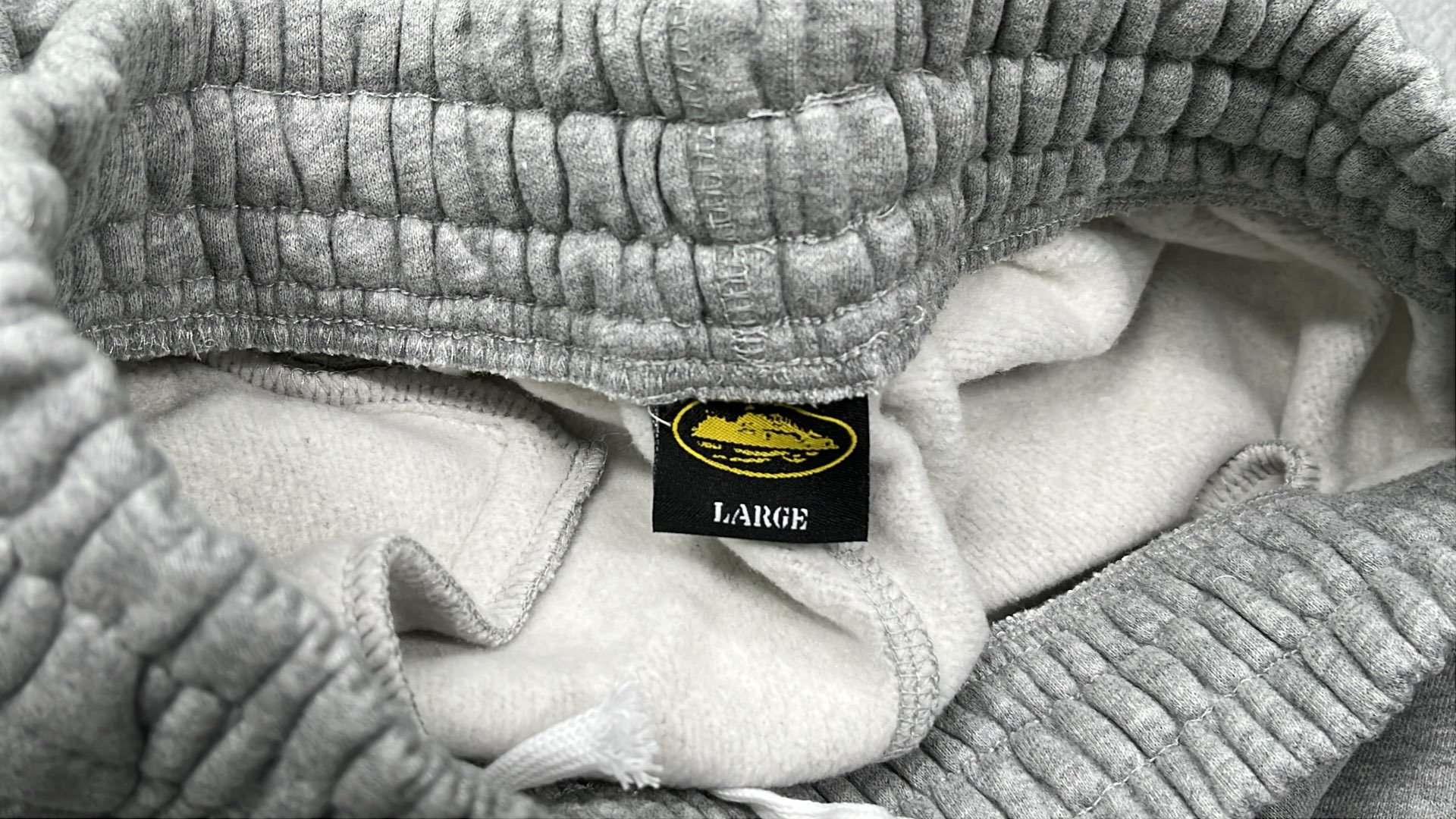 Gray Sweatpants with White Logo Design