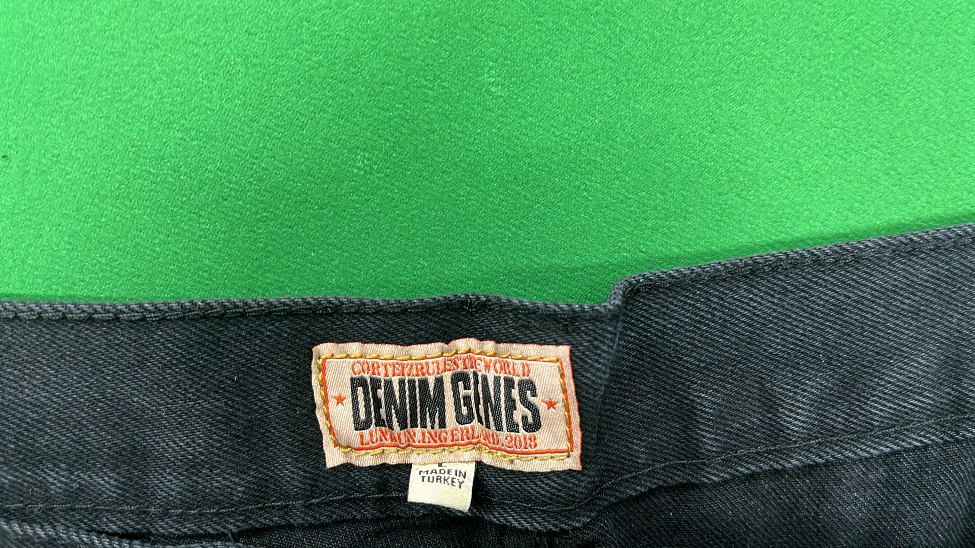 Black Denim Shorts with White Oval Logo Design