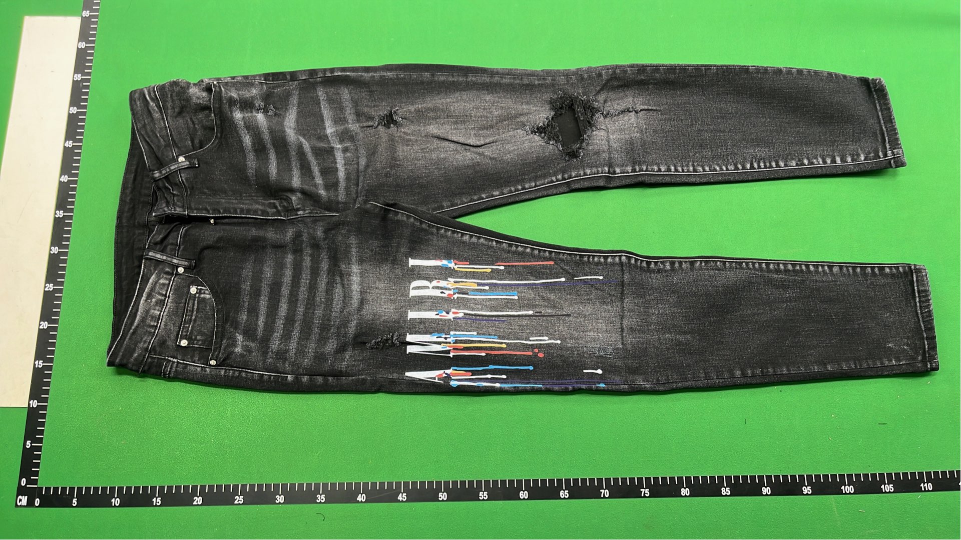 Men's Black Distressed Denim Jeans with Colorful Paint Drip Design